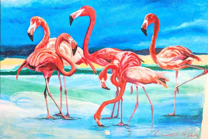 Wall mural of a flock of flamingos standing and grazing in the salt flats. Only one of them is standing on one leg, the classic pose.