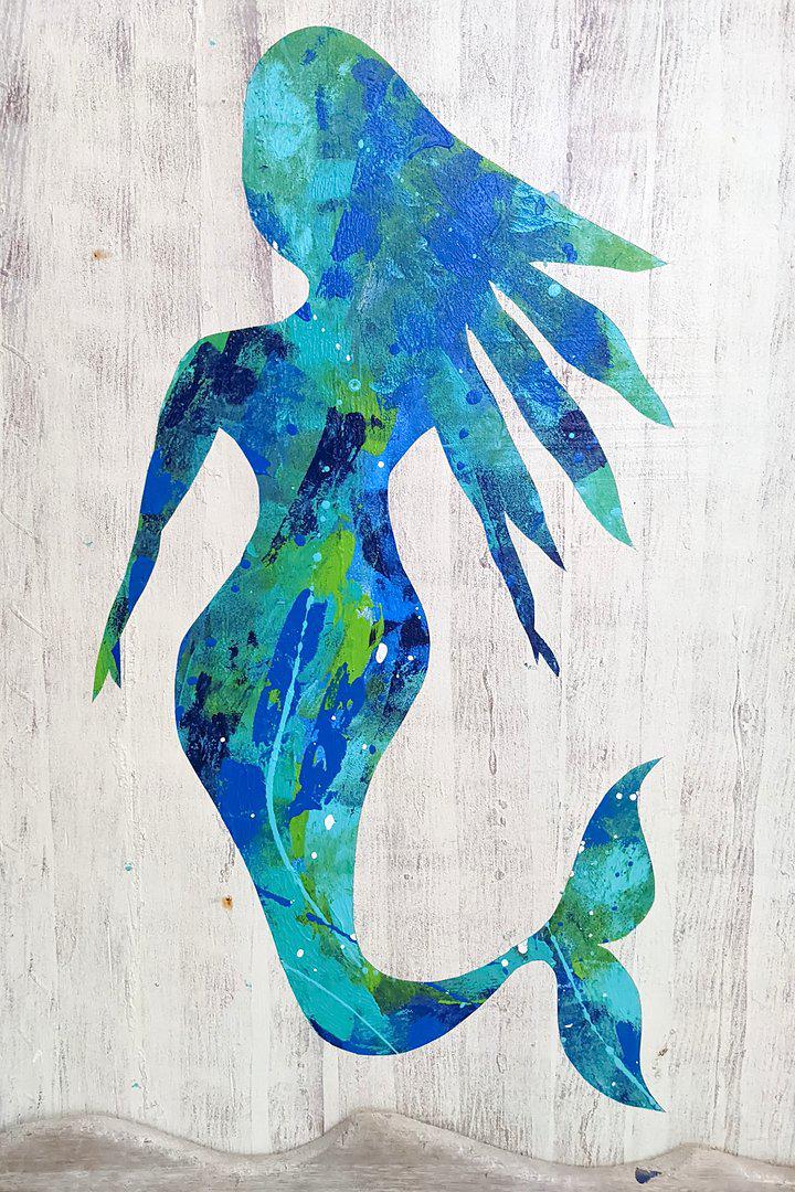 Outline of a mermaid with the middle filled with shades of blue and green paint.