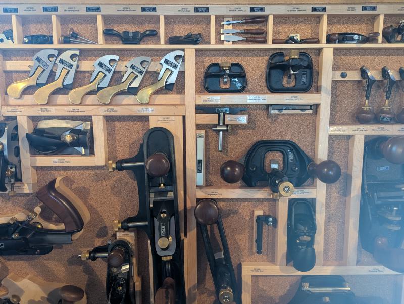 A display of hand tools and there are tiny chisels and planes that look impractical but cute.